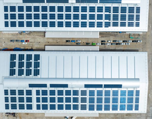 Top view Solar Cell on Warehouse Factory. Solor photo voltaic panels system power or Solar Cell on industrial building roof for producing green ecological electricity. Production of renewable energy.