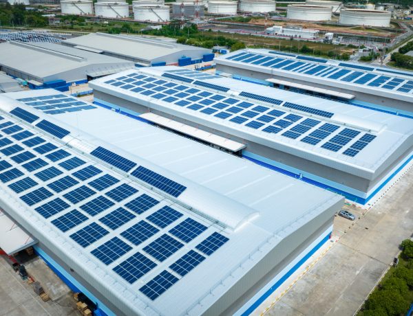 Top view Solar Cell on Warehouse Factory. Solor photo voltaic panels system power or Solar Cell on industrial building roof for producing green ecological electricity. Production of renewable energy.