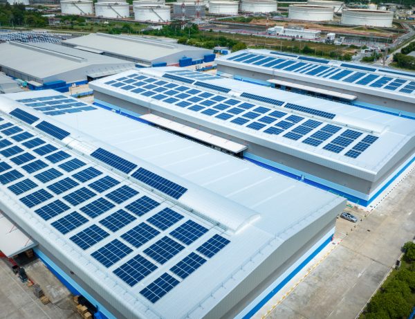 Top view Solar Cell on Warehouse Factory. Solor photo voltaic panels system power or Solar Cell on industrial building roof for producing green ecological electricity. Production of renewable energy.